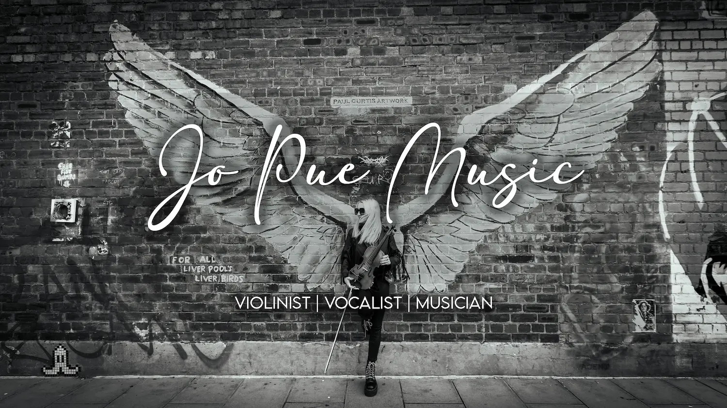 Jo Pue Leaning against a graffiti wall with violin